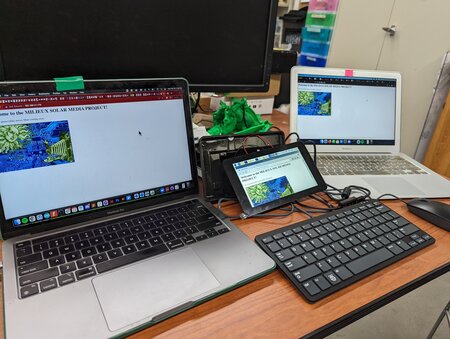Two laptops and a Raspberry Pi computer on a desk